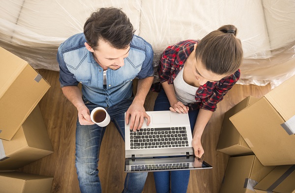 couple sitting among moving boxes