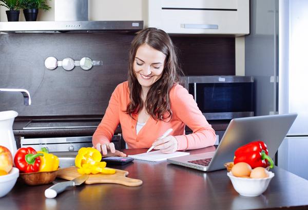 woman in kitchen chopping vegetables