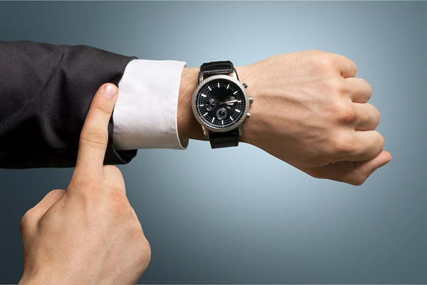 pointing at wristwatch
