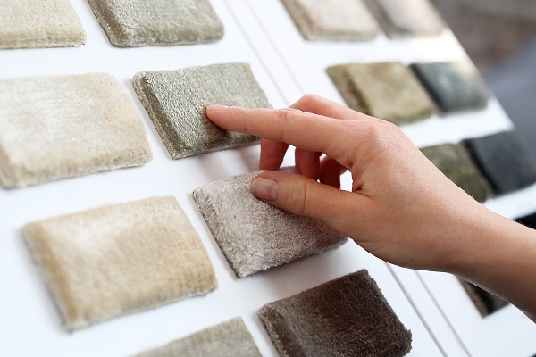 hand touching carpet samples