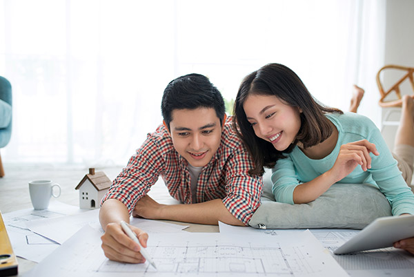 Couple looking at blueprints