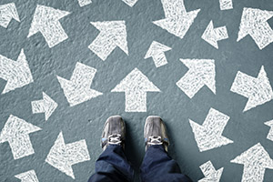 Person standing in front of arrows